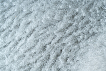 The image is of a fuzzy white fabric with a lot of texture