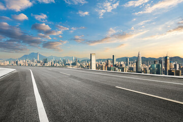 Fototapeta premium Asphalt road and city skyline with mountains in Shenzhen. Modern cityscape and road background.