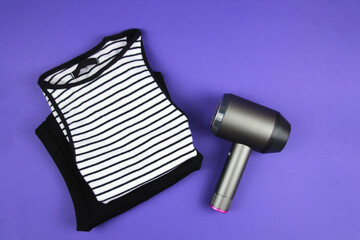 Concept of care and concern for clothes.Pill machine lies on a purple background. Top view.