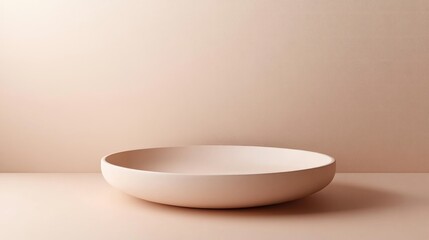 Minimalist ceramic plate in soft blush color on neutral background  