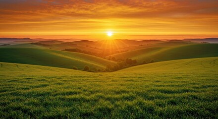 Fototapeta premium A sunrise over rolling green hills, symbolizing renewal and rebirth