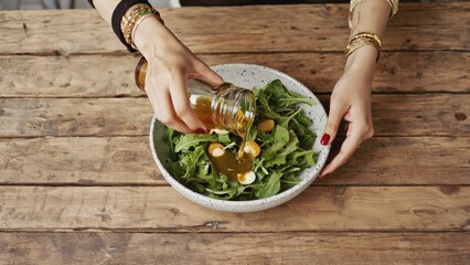 A woman prepares a healthy salad with homemade dressing