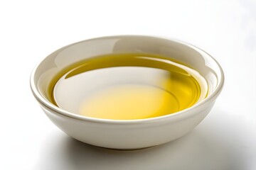 Close-up of yellow cooking oil in a white bowl.