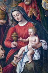 Old painting of Blessed Virgin Mary holding baby Jesus Christ in her arms.