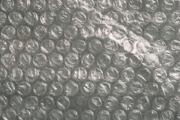 Close-up of bubble wrap texture - transparent plastic packaging film with air-filled cushioning pockets for protection