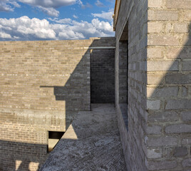 exterior rooms and terrace brick wall unfinished in construction residential ,concrete elements, blue sky sunny day