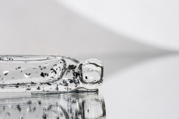 Macro shot of glass dropper with hyaluronic acid serum, skincare beauty product for facial...