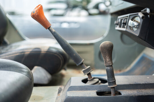 Classic car gearing lever with wooden head handle. Transportation equipment object, close-up and selective focus.