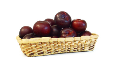 Red plum fruit isolated in basket on white background