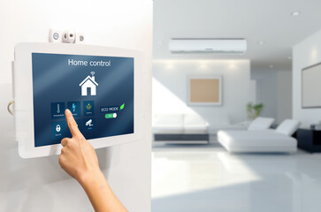 Smart home control App concept.Man using digital tablet on blurred living room as background