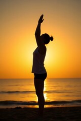 Fototapeta premium Graceful Yoga Practitioner Stretching Silhouette Against Mesmerizing Beach Sunset
