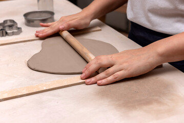 The process of kneading and manufacturing artisanal ceramics and clay by hand and with a wheel, showing the step-by-step process by the hands of a ceramics professional.

