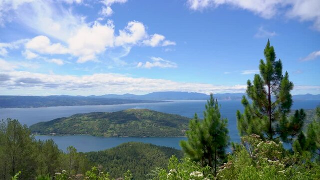 Lake Toba with a foreground of trees. Lake Toba is a large natural lake in North Sumatra