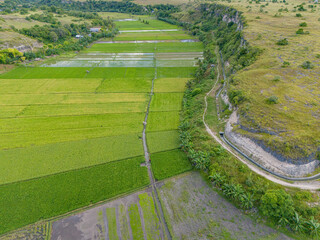 The irrigation ditches watering the valley's rice paddies are neatly laid out, clearly visible...