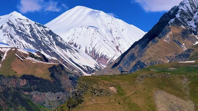 GUDAURI, GEORGIA - APRIL 26, 2024: Scenic view of the Devil's Gorge and the Arch of Friendship. The Caucasus Mountains in the area of the Peoples' Friendship Arch on the Georgian Military Road. 4K