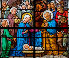 Stained glass (1930) of Christmas Nativity Scene with Virgin Mary, Saint Joseph, and Jesus baby.