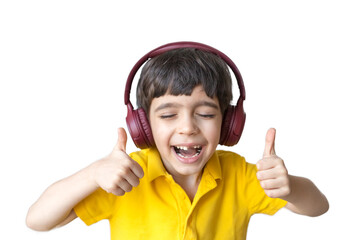 Cute little boy listen to music in headphones, show thumb up gesture, close up. Say no, whims, emotions and facial expression. Like gesture