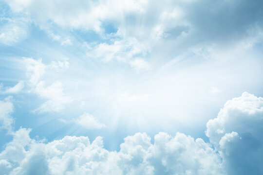 Bright rays of light in blue sky heavenly clouds