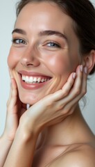 A stunning young woman with flawless, glowing skin beams with joy, her hands gently framing her face. Her bright smile and sparkling eyes radiate happiness and confidence, inviting viewers to share in
