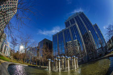 Modern architecture skyscrapers and fountain : urban space of Brussels business district. Glass reflections and pure blue sky.