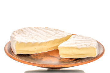 Pieces of fragrant brie cheese on a clay plate isolated on a white background, close-up.