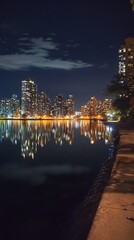 Fototapeta premium A quiet night at a waterfront with the skyline reflecting off the calm water