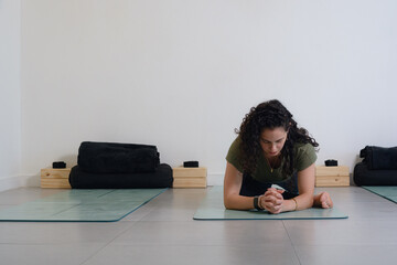 Young woman with great flexibility doing forward bend yoga pose, copy space.