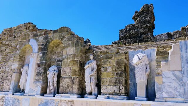 SIDE, TURKEY, June 16, 2024: Ruins of the ancient city of Side in Antalya province on the Mediterranean coast. Amazing ruins of an ancient city. Old statues in the State Agora.The ancient city wall.4K
