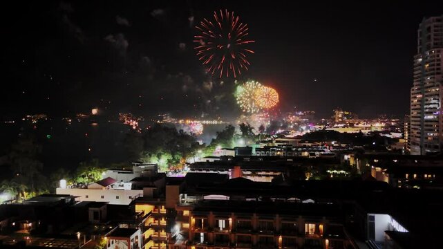 Celebratory fireworks display urban cityscape nighttime event festive environment aerial viewpoint vibrant atmosphere for spectacular occasions