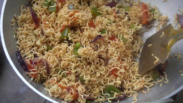 Boil water, add Maggi noodles and seasoning, cook for 2 minutes, stir well, and enjoy a quick, tasty meal.