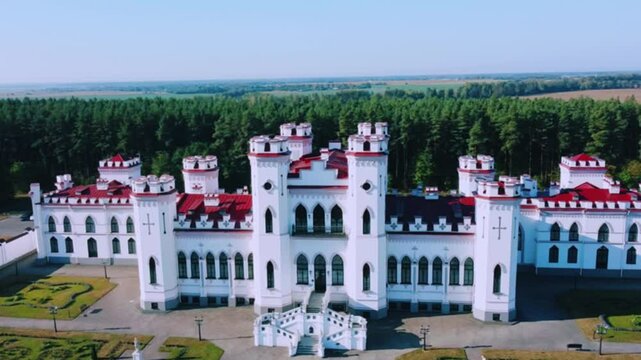 The Puslovsky Palace in Belarus. The Kossovsky Autumn Castle. An old historical castle in the style of English Gothic Revival in Kosovki in sunny autumn weather.Top view.Drone.4K