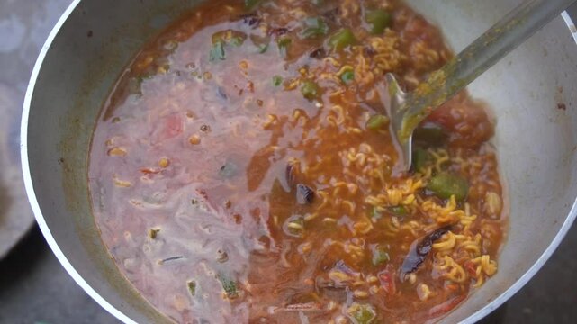 Boil water, add Maggi noodles and seasoning, cook for 2 minutes, stir well, and enjoy a quick, tasty meal.
