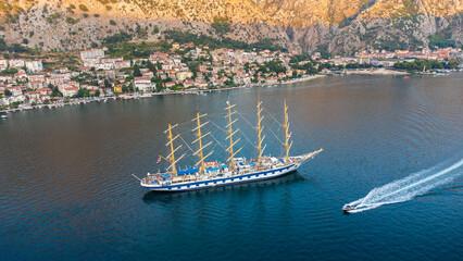 Royal Clipper a five-masted tall ship used as a cruise ship. Aerial view of the sailing ship with another small boat nearby in the adriatic sea in the Bay of Kotor, Montenegro