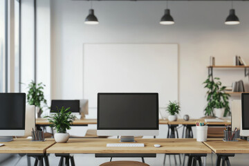 Fototapeta premium A modern office space with wooden desks, desktop computers, potted plants, and shelves background. room is well lit with natural light and hanging