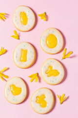 Easter egg cookies with lemon orange curd, covered with white icing and forsythia flowers.