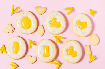 Easter egg cookies with lemon orange curd, covered with white icing and forsythia flowers.