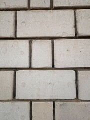 Minimalist close-up of a clean, white brick wall with symmetrical horizontal and vertical lines. The simple, modern aesthetic and subtle imperfections make it ideal for architectural backgrounds or te