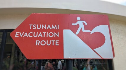 Closeup of tsunami evacuation route warning sign in Denpasar on tropical island of Bali Indonesia