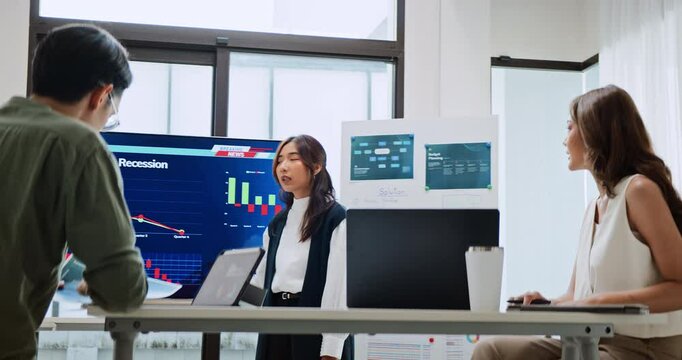 Group of Asian generation z business people work together in home office. Financial team businesspeople brainstorm meeting, use laptop computer and presentation screen. Corporate teamwork concept