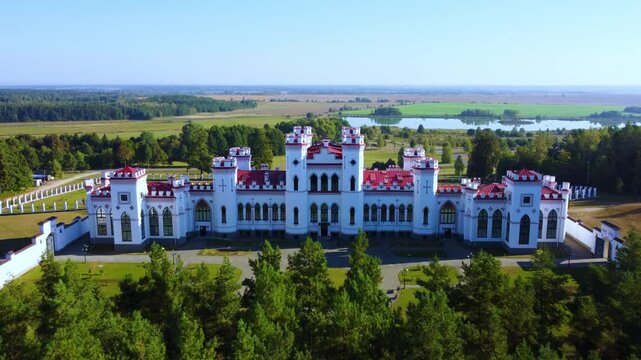 The Puslovsky Palace in Belarus. The Kossovsky Autumn Castle. An old historical castle in the style of English Gothic Revival in Kosovki in sunny autumn weather.Top view.Drone.4K