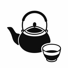 Traditional black iron teapot with a cup on a white background