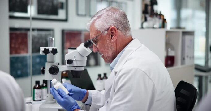 Scientist, man and label on sample in laboratory for cure development, medical innovation and clinical analysis. Science, mature person and sticker on test bottle for pharmaceutical drug and research