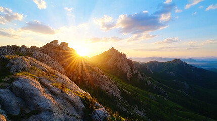 Obraz premium breathtaking view of mountain range at sunset, with sun casting golden rays over rugged peaks and lush green valley below. sky is dotted with fluffy clouds, enhancing serene atmosphere