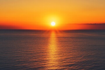 Obraz premium Stunning sunset over the ocean. Blurred view of a fiery orange and yellow sunset over calm water