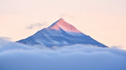 Majestic Mountain Peak Rising Above Clouds at Sunrise in Serene Nature Landscape