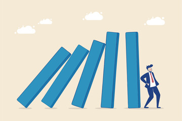 Risk management, uncertainty or unknown threat causing business failure, economic crisis, danger or problem, security and safety concept, courage businessman thinking look at collapsing domino effect.