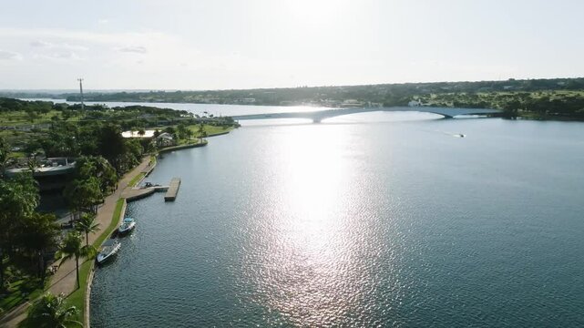 Drone view of Honestino Guimaraees bridge over lake Paranoa in Brazil surrounded by green spaces