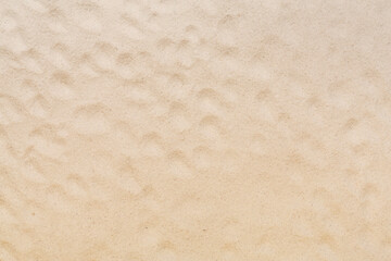 Textured beach sand as background, top view