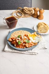 Mexican traditional chilaquiles breakfast red salsa