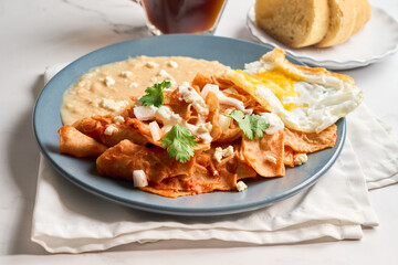 Homemade Mexican Chilaquiles with Fried Egg and Refried Beans